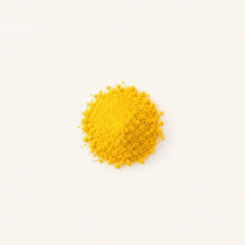 A small mound of Vitamin B6 centered on a clean off-white background.