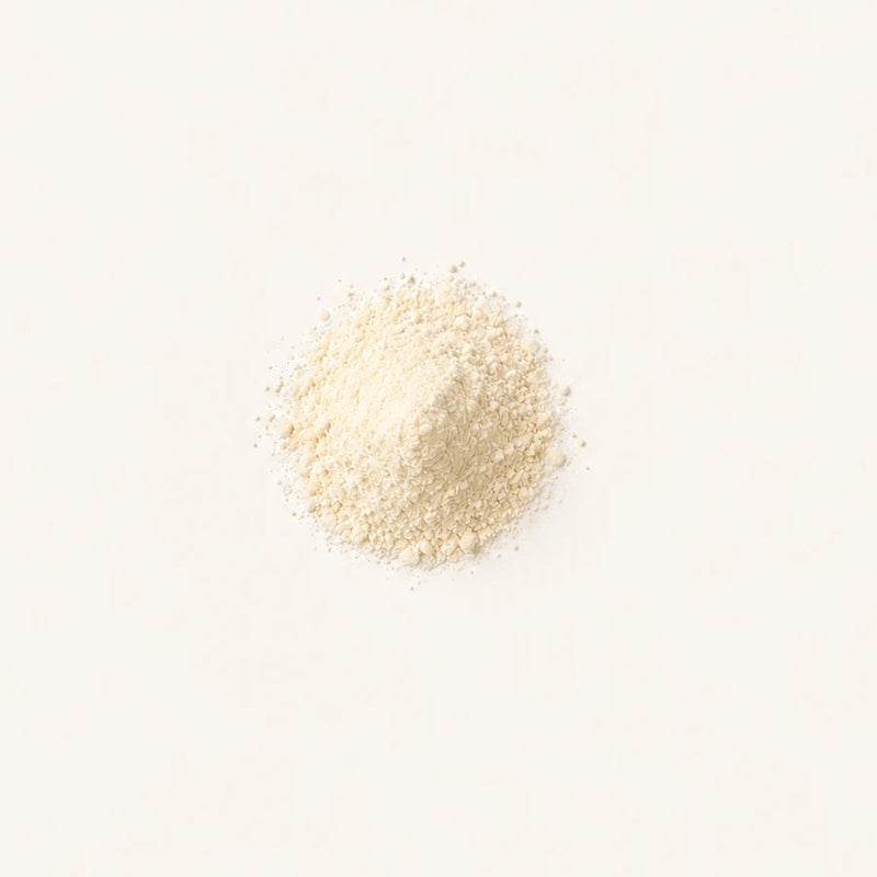 A small mound of Vitamin D3 centered on a plain white background.
