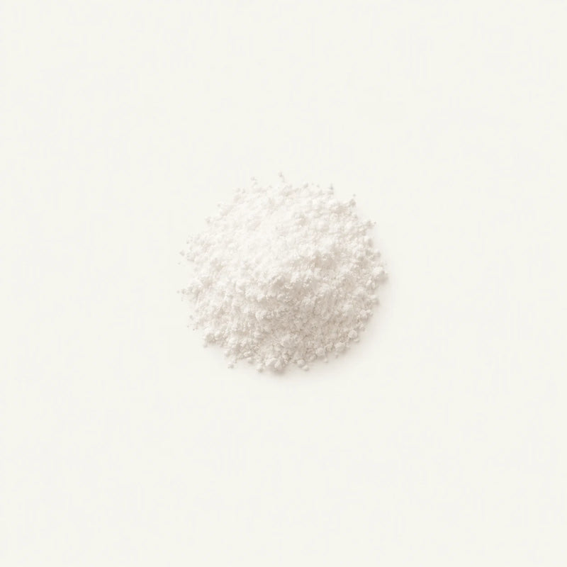 A small mound of Vitamin K2 (MK-7) centered on a plain white background.
