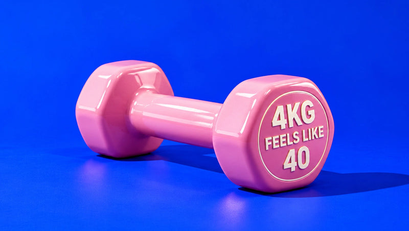 A pink hexagonal dumbbell with '4KG FEELS LIKE 40' printed on the weight plate, set against a solid blue background.